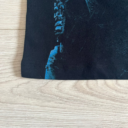 Black Halo 3: ODST Tee for Xbox 360 featuring a large blue Master Chief graphic on the front right and a small logo on the left chest. Made from high-quality cotton with Xbox 360 tags on the collar and a green one on the side. A super rare collectible for Halo fans.