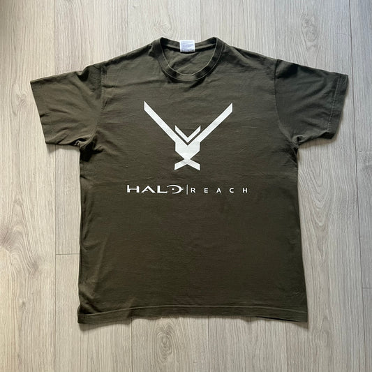 Khaki Halo Reach tee on a Sol’s blank featuring the Noble Team emblem in white on the front and the Halo Reach logo beneath. Small Xbox 360 logo embroidered under the back collar. A classic collectible for fans of the iconic game series.