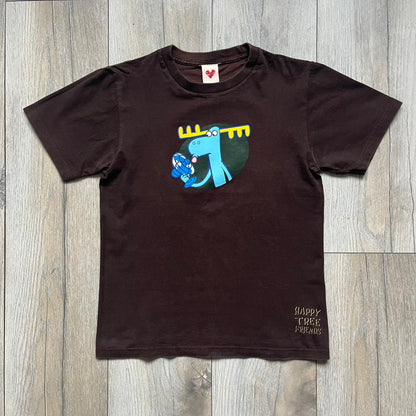 Happy Tree Friends Lumpy Fan Brown Tee from 2005 is a brown T-shirt featuring Lumpy on the front holding and licking a fan. On the back, the same Lumpy graphic appears without the tongue, with visible blood on the fan and face. A small Happy Tree Friends logo is printed in the lower front corner, and the neck tag features a red heart detail.