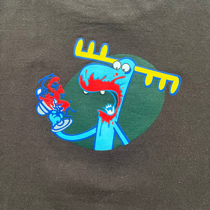 Happy Tree Friends Lumpy Fan Brown Tee from 2005 is a brown T-shirt featuring Lumpy on the front holding and licking a fan. On the back, the same Lumpy graphic appears without the tongue, with visible blood on the fan and face. A small Happy Tree Friends logo is printed in the lower front corner, and the neck tag features a red heart detail.