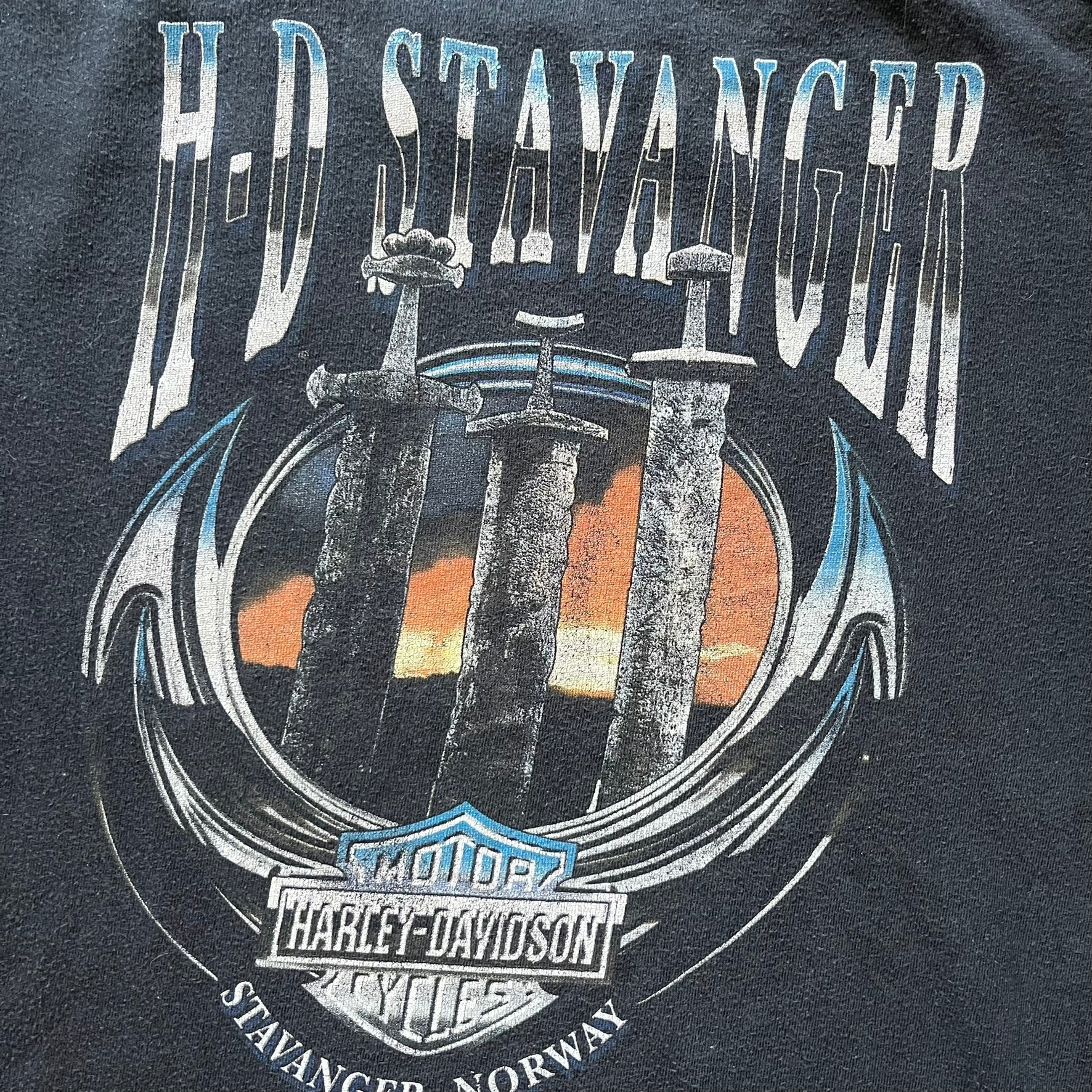 Black Harley Davidson t-shirt from 2011 with striking skull and Harley branding on the chest. Back print features the Stavenger Norway logo and date for an authentic rally vibe. Perfect for fans of vintage motorcycle style.