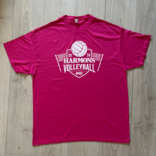 Pink t-shirt with 'Harmon's Volleyball' logo on a wooden surface