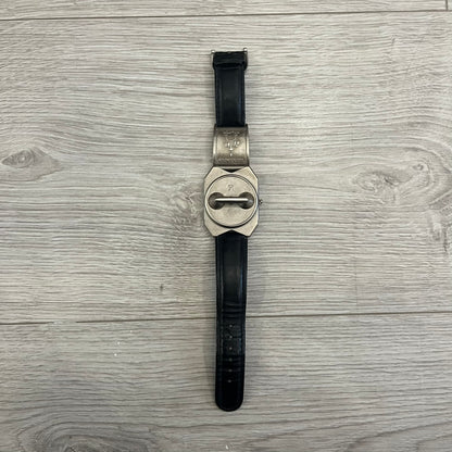 Hi-Tek Alexander “Jump Hour” 90's Analog Watch with a rare octagonal steel case and innovative rotation disc display. Hours appear in the left window and minutes in the right, revealed by the unique turnable cover. Made in England, this vintage 1990s watch features a chrome-plated stainless steel case, genuine leather strap, and an original design by Alexander Tasou of Hi-Tek Designs London. A true collector’s piece that is no longer in production.