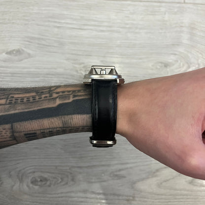 Hi-Tek Alexander “Jump Hour” 90's Analog Watch with a rare octagonal steel case and innovative rotation disc display. Hours appear in the left window and minutes in the right, revealed by the unique turnable cover. Made in England, this vintage 1990s watch features a chrome-plated stainless steel case, genuine leather strap, and an original design by Alexander Tasou of Hi-Tek Designs London. A true collector’s piece that is no longer in production.