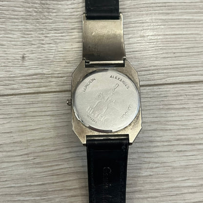 Hi-Tek Alexander “Jump Hour” 90's Analog Watch with a rare octagonal steel case and innovative rotation disc display. Hours appear in the left window and minutes in the right, revealed by the unique turnable cover. Made in England, this vintage 1990s watch features a chrome-plated stainless steel case, genuine leather strap, and an original design by Alexander Tasou of Hi-Tek Designs London. A true collector’s piece that is no longer in production.