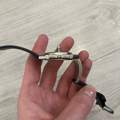 Hi-Tek Alexander “Jump Hour” 90's Analog Watch with a rare octagonal steel case and innovative rotation disc display. Hours appear in the left window and minutes in the right, revealed by the unique turnable cover. Made in England, this vintage 1990s watch features a chrome-plated stainless steel case, genuine leather strap, and an original design by Alexander Tasou of Hi-Tek Designs London. A true collector’s piece that is no longer in production.