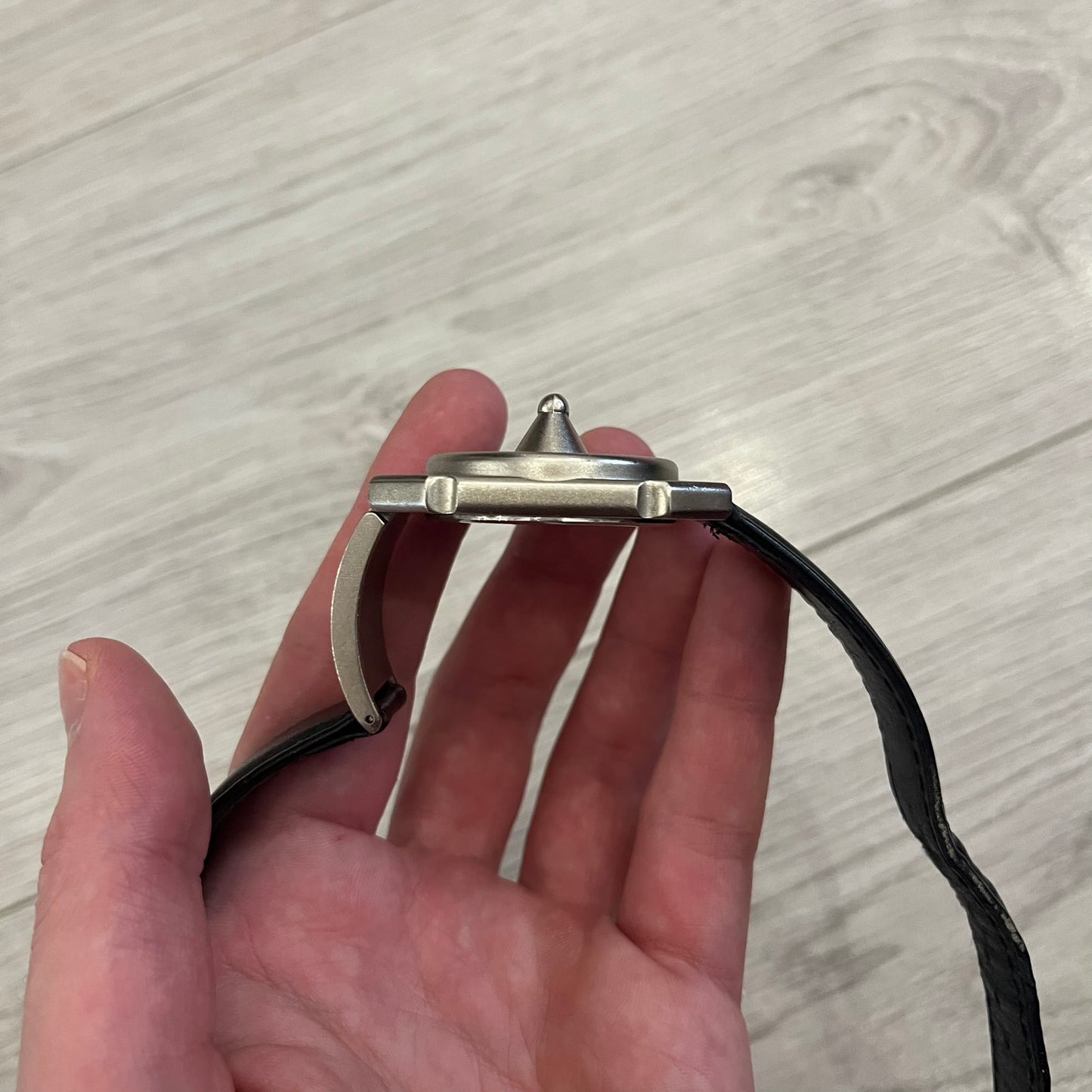 Hi-Tek Alexander “Jump Hour” 90's Analog Watch with a rare octagonal steel case and innovative rotation disc display. Hours appear in the left window and minutes in the right, revealed by the unique turnable cover. Made in England, this vintage 1990s watch features a chrome-plated stainless steel case, genuine leather strap, and an original design by Alexander Tasou of Hi-Tek Designs London. A true collector’s piece that is no longer in production.