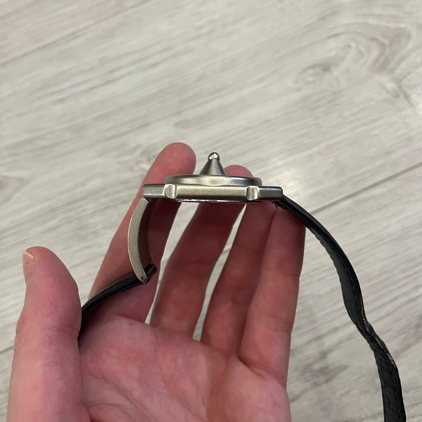 Hi-Tek Alexander “Jump Hour” 90's Analog Watch with a rare octagonal steel case and innovative rotation disc display. Hours appear in the left window and minutes in the right, revealed by the unique turnable cover. Made in England, this vintage 1990s watch features a chrome-plated stainless steel case, genuine leather strap, and an original design by Alexander Tasou of Hi-Tek Designs London. A true collector’s piece that is no longer in production.