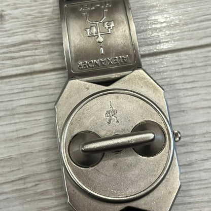 Hi-Tek Alexander “Jump Hour” 90's Analog Watch with a rare octagonal steel case and innovative rotation disc display. Hours appear in the left window and minutes in the right, revealed by the unique turnable cover. Made in England, this vintage 1990s watch features a chrome-plated stainless steel case, genuine leather strap, and an original design by Alexander Tasou of Hi-Tek Designs London. A true collector’s piece that is no longer in production.