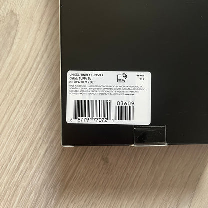 Product label on a black surface with a wooden background