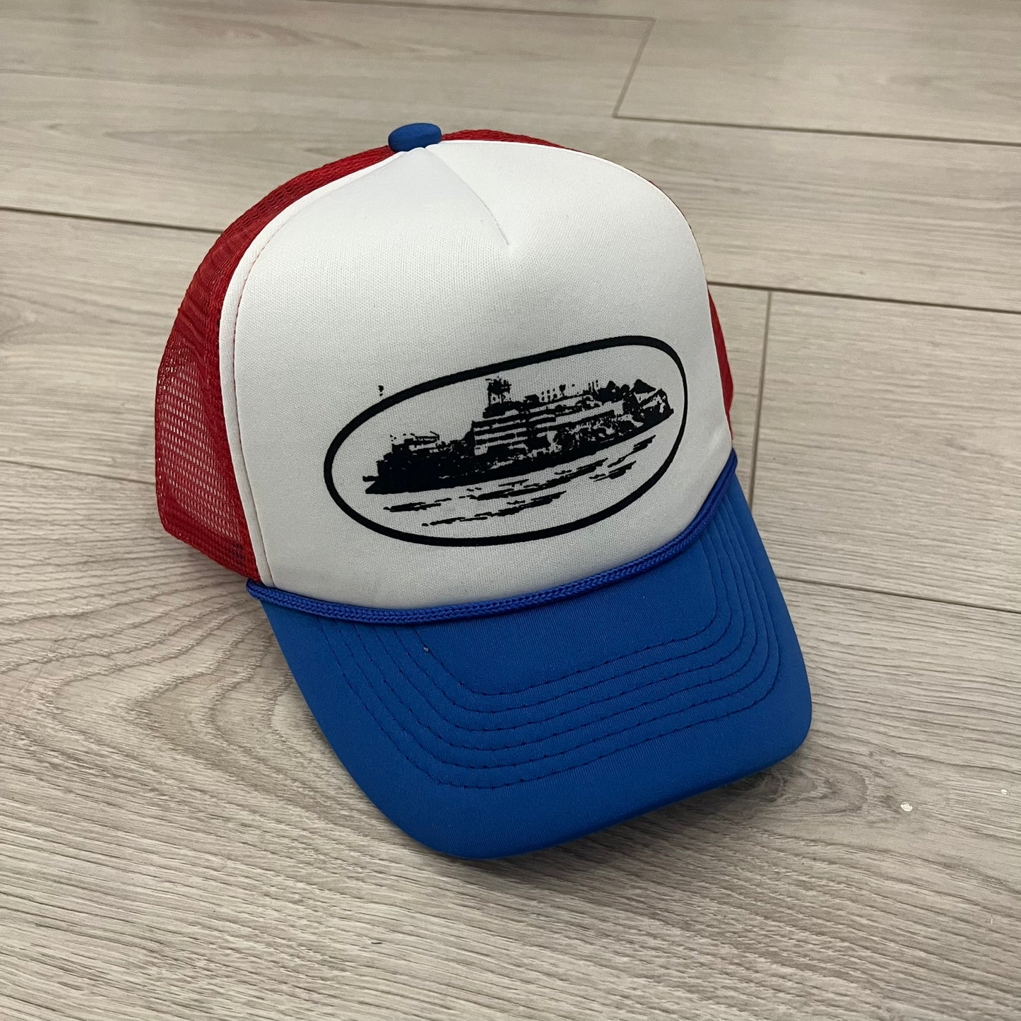 corteiz alcatraz trucker hat white blue red