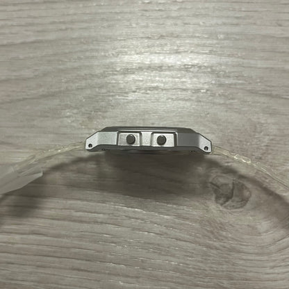 Metal bracket with two screws on a wooden surface