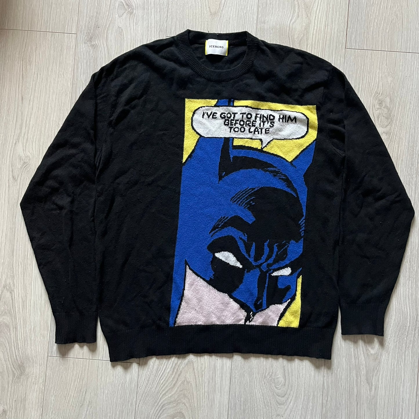 Iceberg Batman 2016 Black Sweater crafted from a premium blend of polyamide, wool, cashmere, and viscose. Features a large woven Batman comic-style graphic on a yellow background with the quote “I’ve got to find him before it’s too late.” Officially licensed by DC, released as part of the Spring/Summer 2016 collection.