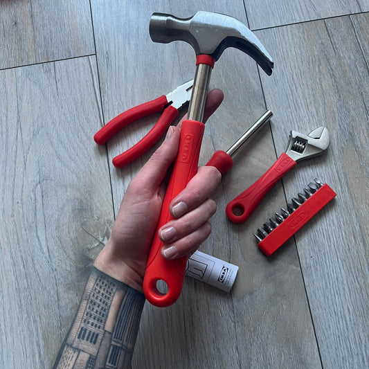 Orange/red toolkit from IKEA x Virgil Abloh MARKERAD collection, released 11/01/2019. Includes four tools: hammer, screwdriver, pliers, and wrench, all in matching orange/red color. Original IKEA release, part of the limited MARKERAD capsule.