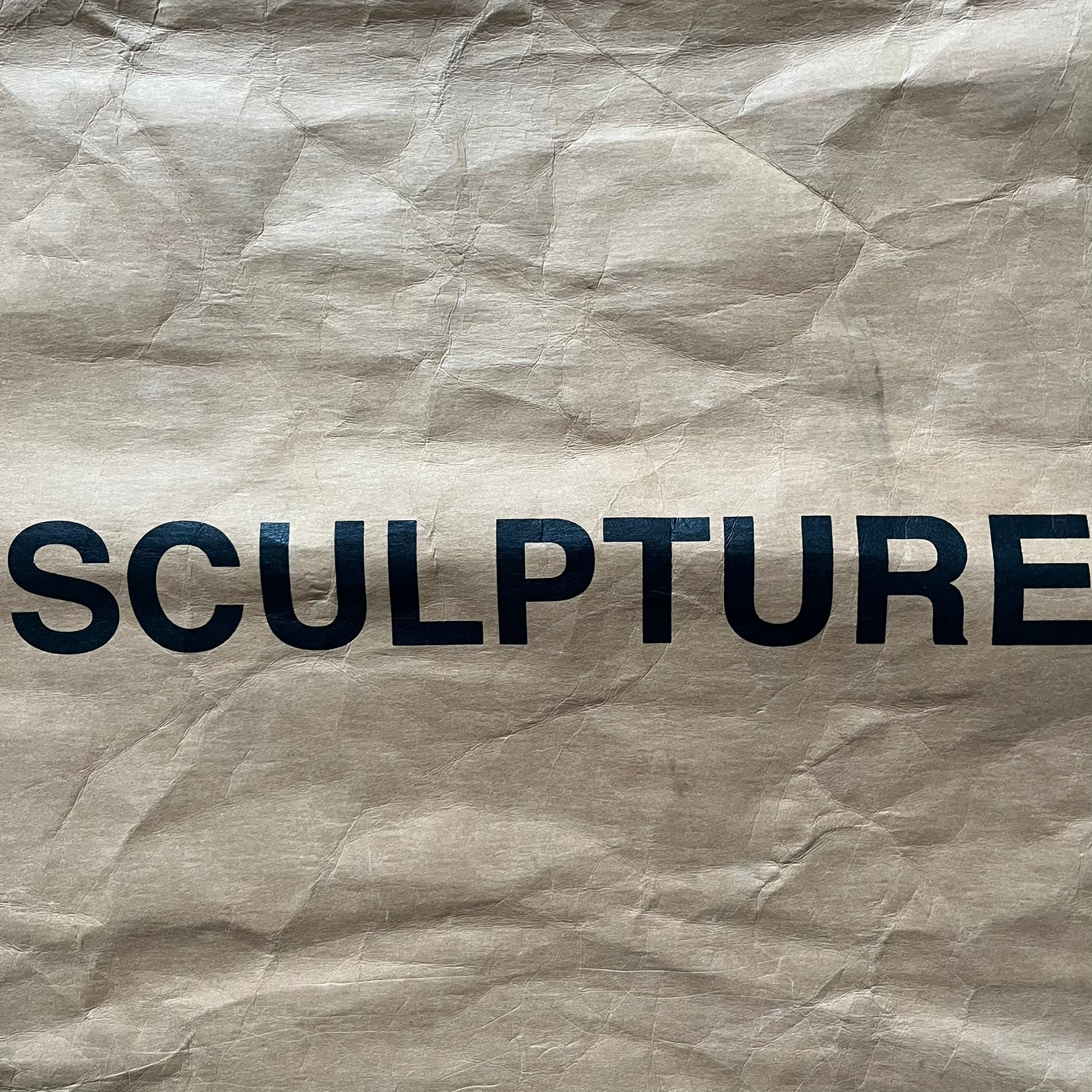 Ikea x Virgil Abloh Markerad "Sculpture" Carrier Bag from FW19 reimagines the iconic blue Frakta tote in reinforced brown paper. Embellished with Abloh’s signature quotation marks, the “SCULPTURE” print transforms a utilitarian object into conceptual design. A collectible symbol of functional art and everyday irony.