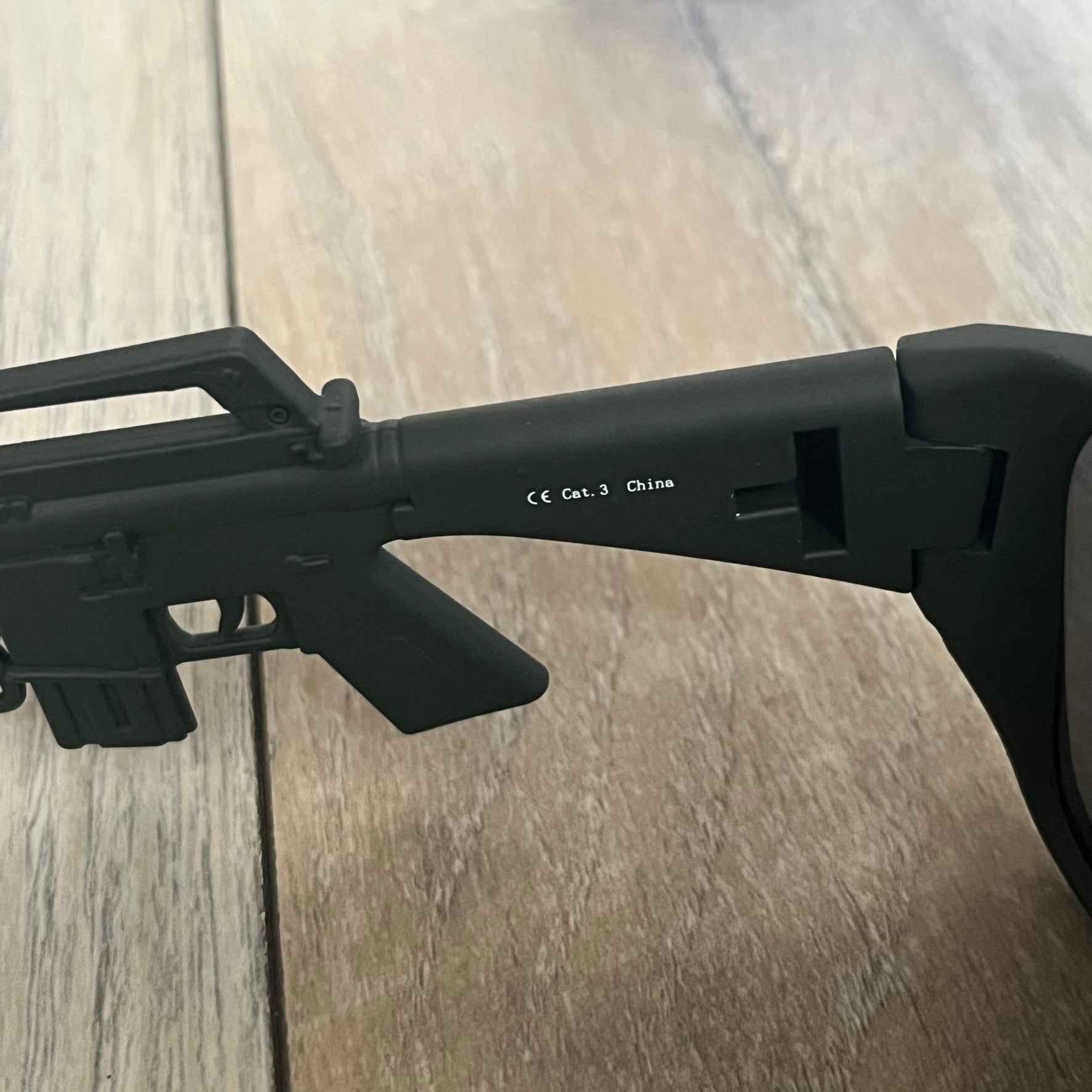 Jeremy Scott x Linda Farrow SS2013 Matt Khaki M16 Rifle Sunglasses (JSARMYC5SUN) are a statement eyewear piece from the Spring/Summer 2013 collaboration. The design features full matt dark khaki frames with black lenses, while the arms are constructed as detailed 3D M16 rifle shapes extending toward the front of the frame. The model includes Jeremy Scott branding on the inner arms and is produced in a high-detail acetate construction.