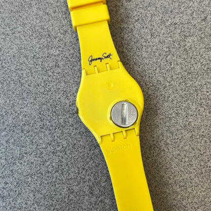 Swatch x Jeremy Scott 2011 Punk Analog Watch GZ251 is a quartz watch from the Gent Original line featuring a bright green dial with black hands and a plastic case. The design includes a comically long silicone strap with leopard print that wraps twice around the wrist, secured with multiple yellow loops, and Jeremy Scott branding on the upper strap.