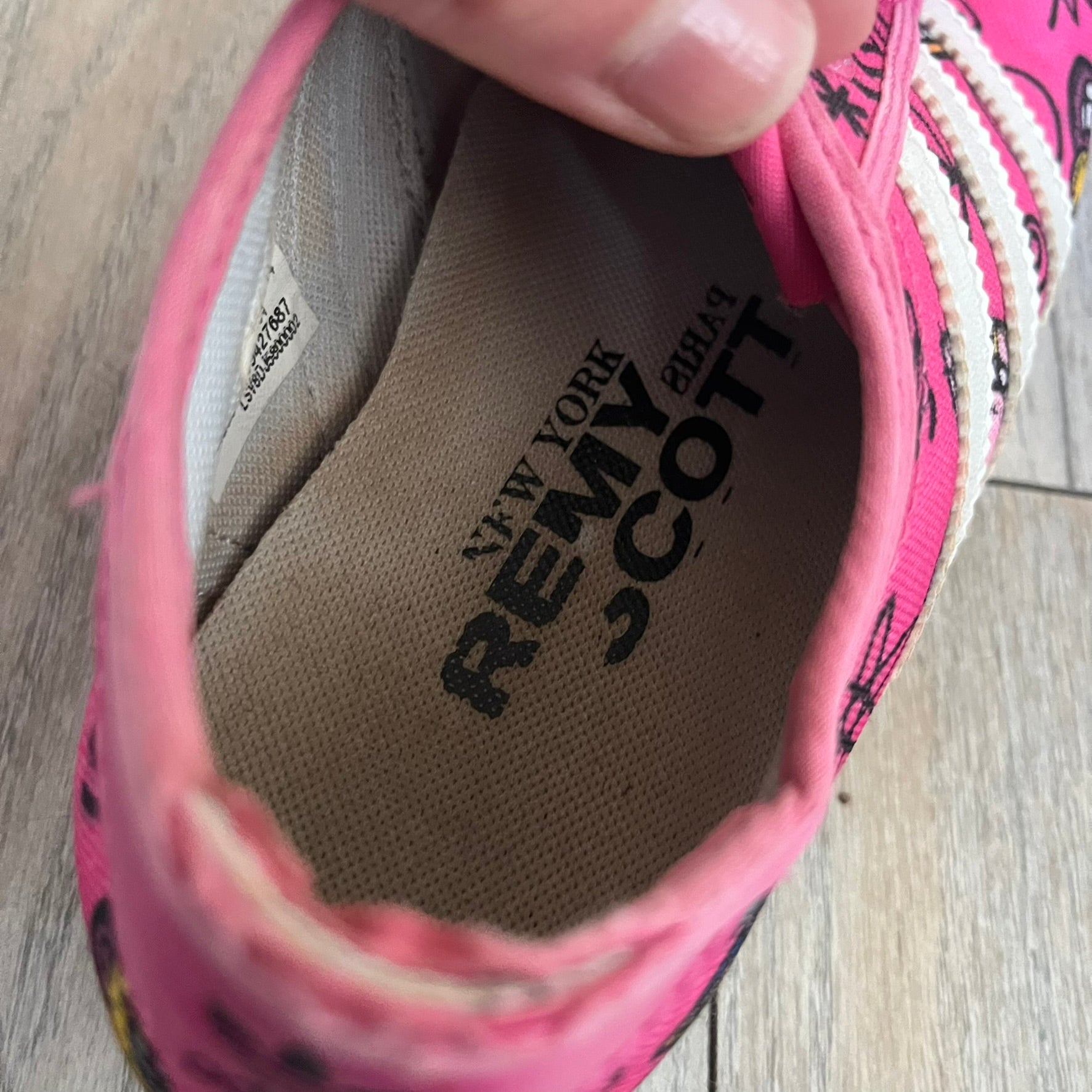Jeremy Scott x adidas 2014 P-Sole “Pink” Sneakers feature a pink canvas upper with white leather adidas stripes and multicolored graphic prints. Released in 2014, they are part of the P-Sole line in the collaboration between adidas Originals, Jeremy Scott, and Kenny Scharf. The shoes include standard rubber soles and lace-up closure.
