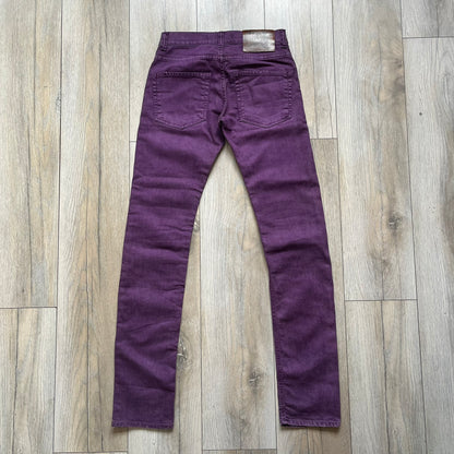 Just Cavalli 2010s Purple Slim Jeans are slim-fit denim jeans finished in a full purple colorway. The pair features classic front and back pocket construction, branded metal button closure, and small metal stud details on the pockets. Additional details include a rear leather Just Cavalli logo patch, interior Just Cavalli tag, and original paper tag.