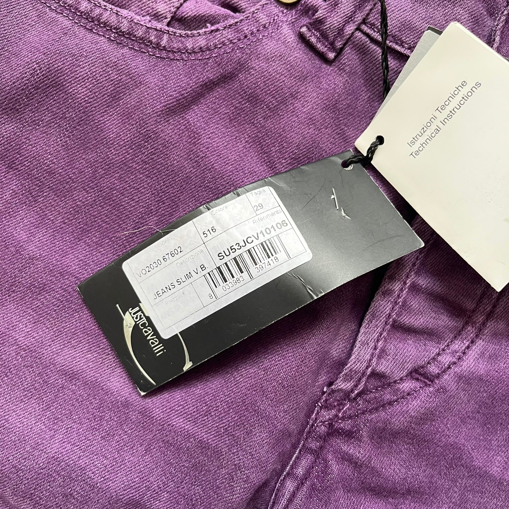 Just Cavalli 2010s Purple Slim Jeans are slim-fit denim jeans finished in a full purple colorway. The pair features classic front and back pocket construction, branded metal button closure, and small metal stud details on the pockets. Additional details include a rear leather Just Cavalli logo patch, interior Just Cavalli tag, and original paper tag.