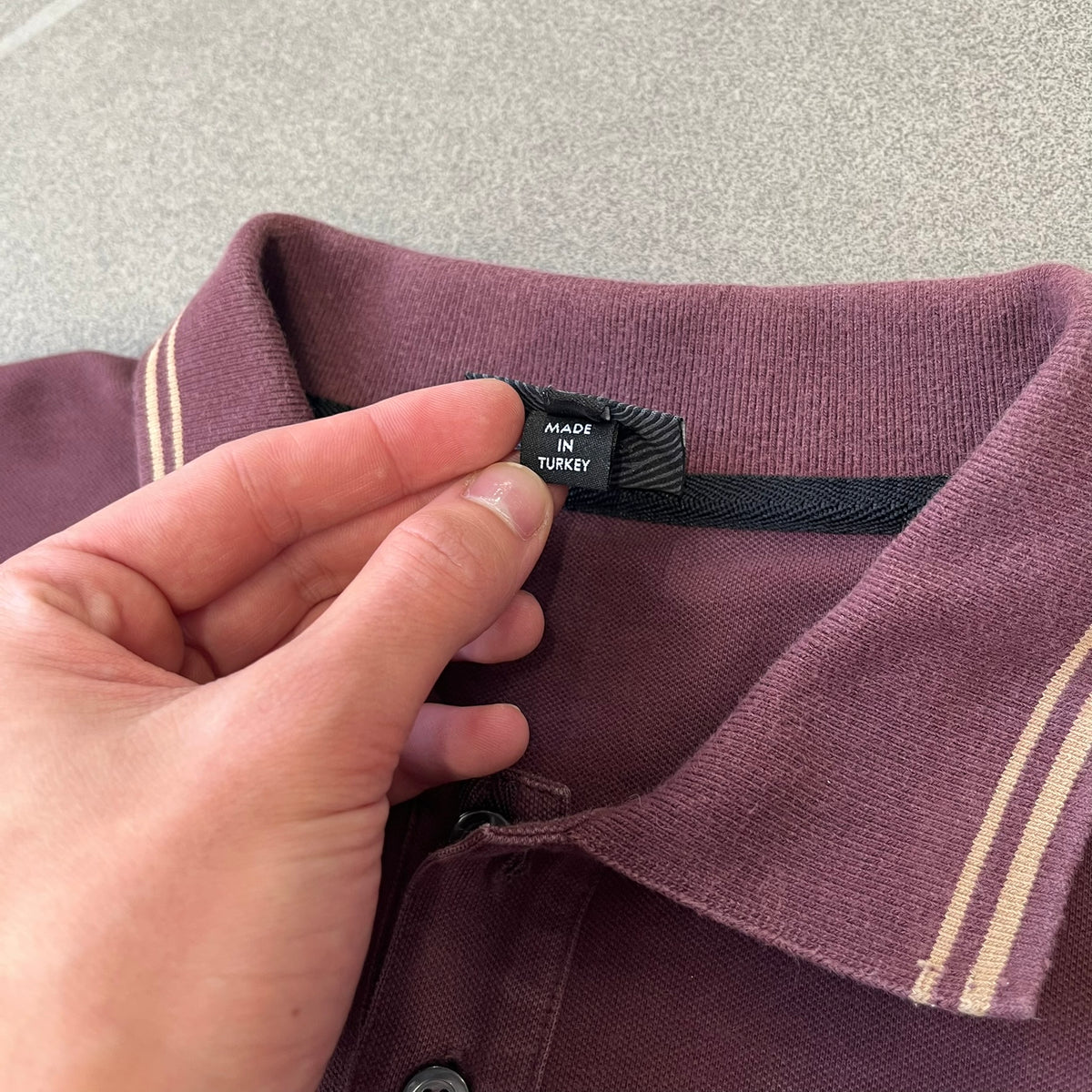 Just Cavalli 2017 Leopard Patch Polo is a burgundy, 100% cotton polo with gold/yellow trim along the hems and collar, featuring a roaring leopard patch on the chest and a small Cavalli side tag. It has side vents at the hem, typical of the polo style.