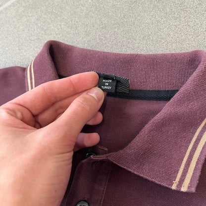 Just Cavalli 2017 Leopard Patch Polo is a burgundy, 100% cotton polo with gold/yellow trim along the hems and collar, featuring a roaring leopard patch on the chest and a small Cavalli side tag. It has side vents at the hem, typical of the polo style.