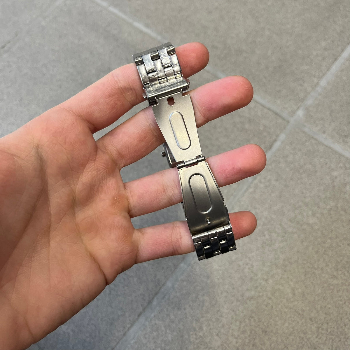 Just Cavalli Colas 2010’s Zebra Analog Watch is a stainless steel analog watch with a white and black zebra print dial and a silver Just Cavalli logo. The band matches the width of the case and has crystal details, and “Cavalli” is engraved on one side of the case.