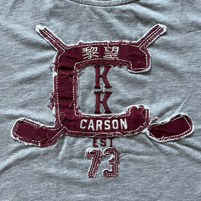 Maroon patch with 'Carrson' text on a gray fabric background