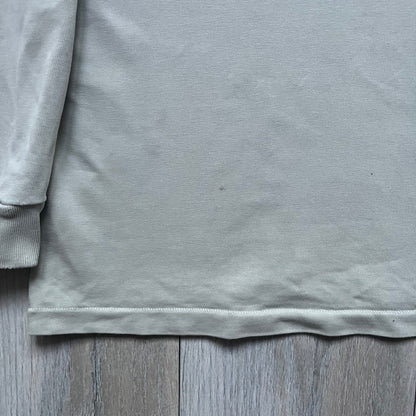 Longsleeve tee from the FW18 Kanye West x Pornhub collection, released 09/07/2018. Vapor color, featuring a front illustration of Riley Reid with her name above and “Top Female Performer” below. Back has the numbers “6918” (futuristic theme set in the year 6918). Includes printed Pornhub tag and YEEZY wash tag, part of a limited run commemorating the 2018 Pornhub Awards.