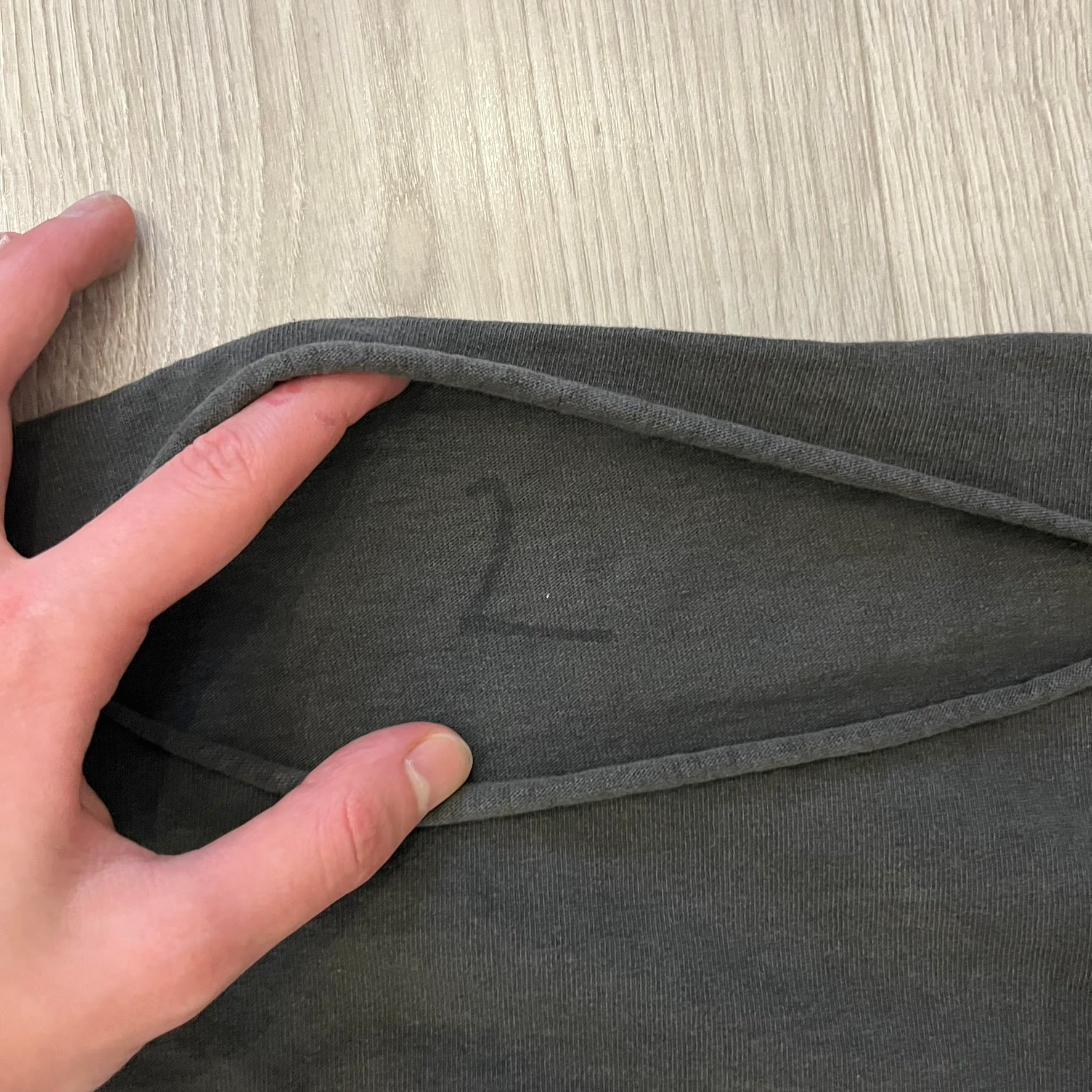 Kanye West Vultures Box Tee in washed black features a large Vultures Eagles logo on the back and a smaller matching logo on the chest. Designed with an oversized, boxy silhouette, this T-shirt offers a relaxed fit. Made from high-quality, durable materials, it provides comfort for everyday wear while showcasing Yeezy’s distinctive style.