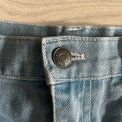 The Karl Kani Signature Eagle Printed Jeans feature a multi-tone eagle graphic over a mountain landscape on a classic blue denim base. Made from 100% cotton, these baggy jeans have a relaxed, wide-leg fit with straight cut legs, a button and zip fastening, and embroidered Karl Kani branding on the back and front pockets. The all-over print extends across the front and back, creating a unique and vintage-inspired look from the FW22 Season.