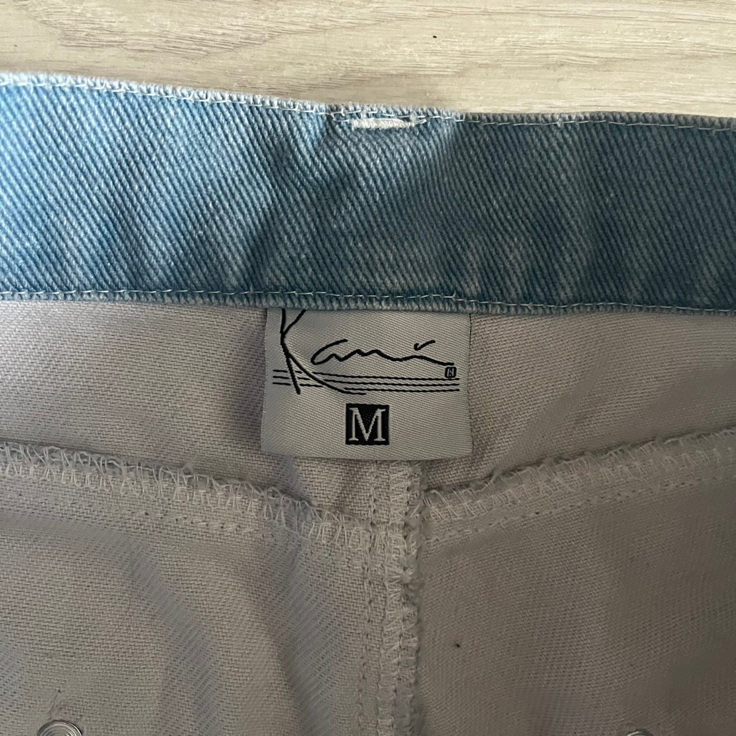 The Karl Kani Signature Eagle Printed Jeans feature a multi-tone eagle graphic over a mountain landscape on a classic blue denim base. Made from 100% cotton, these baggy jeans have a relaxed, wide-leg fit with straight cut legs, a button and zip fastening, and embroidered Karl Kani branding on the back and front pockets. The all-over print extends across the front and back, creating a unique and vintage-inspired look from the FW22 Season.