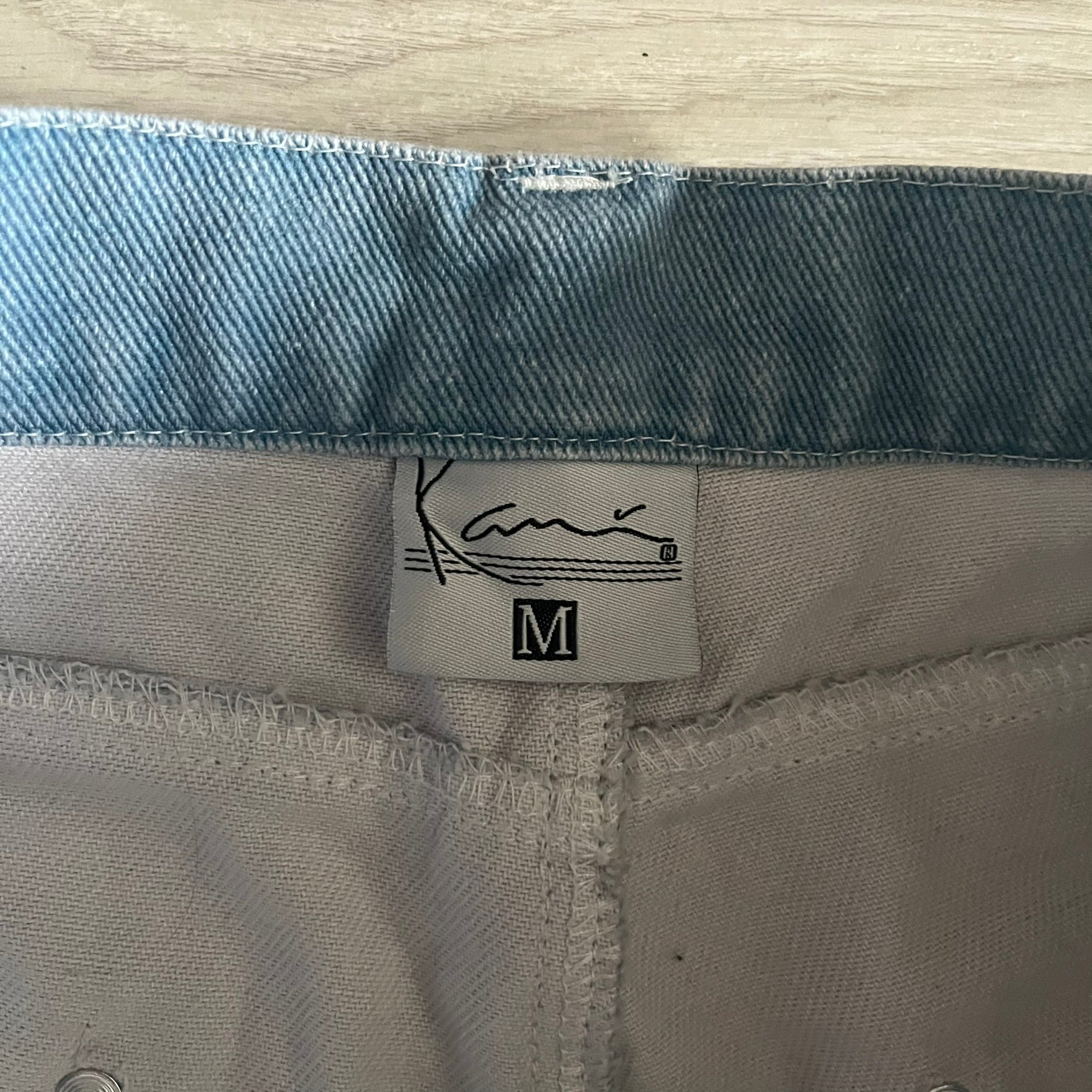 The Karl Kani Signature Eagle Printed Jeans feature a multi-tone eagle graphic over a mountain landscape on a classic blue denim base. Made from 100% cotton, these baggy jeans have a relaxed, wide-leg fit with straight cut legs, a button and zip fastening, and embroidered Karl Kani branding on the back and front pockets. The all-over print extends across the front and back, creating a unique and vintage-inspired look from the FW22 Season.