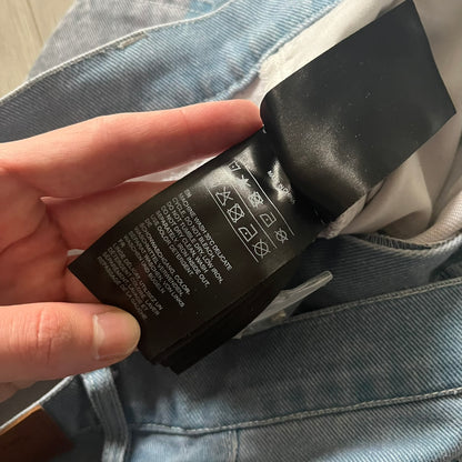 The Karl Kani Signature Eagle Printed Jeans feature a multi-tone eagle graphic over a mountain landscape on a classic blue denim base. Made from 100% cotton, these baggy jeans have a relaxed, wide-leg fit with straight cut legs, a button and zip fastening, and embroidered Karl Kani branding on the back and front pockets. The all-over print extends across the front and back, creating a unique and vintage-inspired look from the FW22 Season.