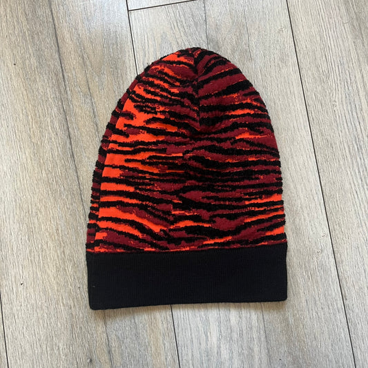 Kenzo x H&amp;M Orange Tiger Camo Beanie is a knit beanie from the 2016 collaboration. It features an all-over tiger camouflage pattern in red, orange, and dark red tones, woven directly into the fabric. The design is finished with a black cuff and can be worn either slouched or folded for a more traditional beanie fit.