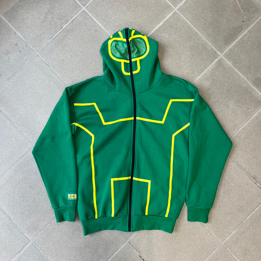 Kick-Ass 2 Full Zip 2013 Promo Hoodie is a green full-zip hoodie with yellow printed lines matching the costume worn by Kick-Ass in Kick-Ass 2. The zipper extends through the hood, allowing it to close into a mask with see-through mesh eye panels. It features a Kick-Ass 2 (2013) Universal Studios licensed neck tag, a matching movie logo patch on the sleeve, and is made in the USA.
