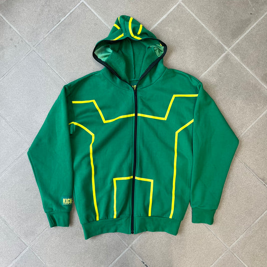 Kick-Ass 2 Full Zip 2013 Promo Hoodie is a green full-zip hoodie with yellow printed lines matching the costume worn by Kick-Ass in Kick-Ass 2. The zipper extends through the hood, allowing it to close into a mask with see-through mesh eye panels. It features a Kick-Ass 2 (2013) Universal Studios licensed neck tag, a matching movie logo patch on the sleeve, and is made in the USA.
