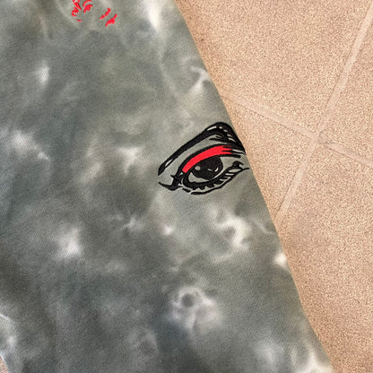 KidSuper Studios FW21 Tie-Dye Sweatpants feature a white and grey tie-dye colorway with multiple embroidered details throughout. The sweatpants include a blue KidSuper logo, eye graphics, “Resenha” text, text on the drawstrings, and additional embroidery on the back pockets. Finished with a pink size tag.