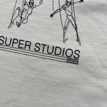 KidSuper Studios SS25 “String Puppets” Cream Tee is a cream short-sleeve T-shirt from the Spring/Summer 2025 collection. The front features five black string puppet-style figures on the chest, with “Kidsuper Studios 2025” text/logo printed underneath. The shirt includes a blue SS25 KidSuper neck tag.