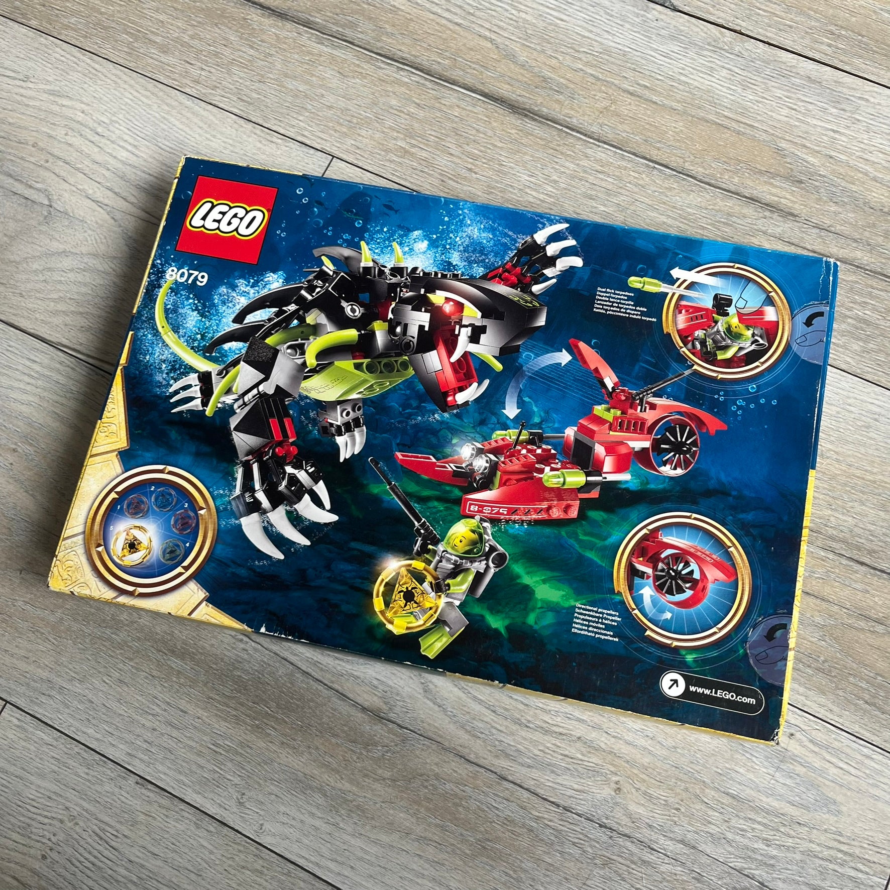 LEGO Atlantis 8079 Shadow Snapper Set is a 2010 release consisting of 246 pieces. The set includes a Shadow Snapper creature, a combat sub with dual flick-launching torpedoes and spinning propeller, a deep-sea diver minifigure (Lance Spears), a Monster Turtle, and an exclusive yellow Atlantis treasure key. The Shadow Snapper measures approximately 20 cm in length, while the sub measures around 12 cm.