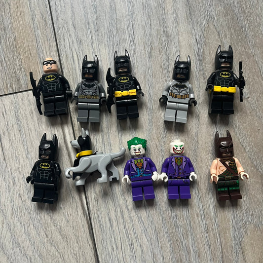LEGO Batman & Joker 10 Minifigures is a collection of 10 LEGO minifigures featuring Batman and Joker characters from various sets. The lot includes 4x sh0312, 1x sh458, 1x sh151, 1x sh304, 1x sh354, 1x sh515, and 1x 30533c02. Figures come in different conditions and originate from multiple official LEGO releases.