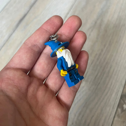LEGO Kingdoms 853088 Majisto Wizard Keychain is a 2011 release featuring a LEGO Kingdoms Wizard (Majisto) minifigure attached to a sturdy metal key chain. The minifigure is fixed to the chain and designed for use as a keychain or backpack accessory.
