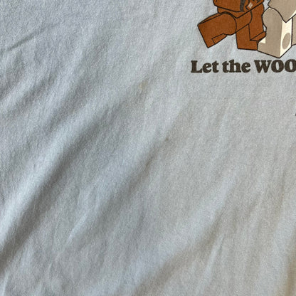 LEGO Star Wars 2007 “Let the WOOKIEE win!” Tee is a light blue, 100% cotton T-shirt with a front graphic of LEGO Chewbacca and two Stormtroopers, with Chewbacca holding the hands of one while the other stands to the side with a blaster. “Let the Wookiee win” text sits below the graphic, along with a small LEGO Star Wars logo and 2007 licensing. It has a Star Wars neck tag.