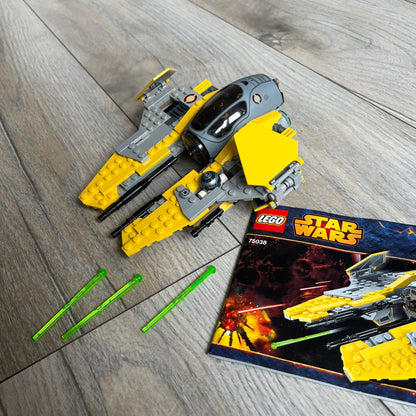 LEGO Star Wars 75038 Jedi Interceptor Set is a 2014 release featuring Anakin Skywalker’s yellow Eta-2 Actis-Class Interceptor. The set includes Anakin Skywalker minifigure with headset and lightsaber, along with an R2-D2 figure. The build features an opening cockpit, folding wing flaps, and dual spring-loaded shooters, measuring approximately 19 cm in length.