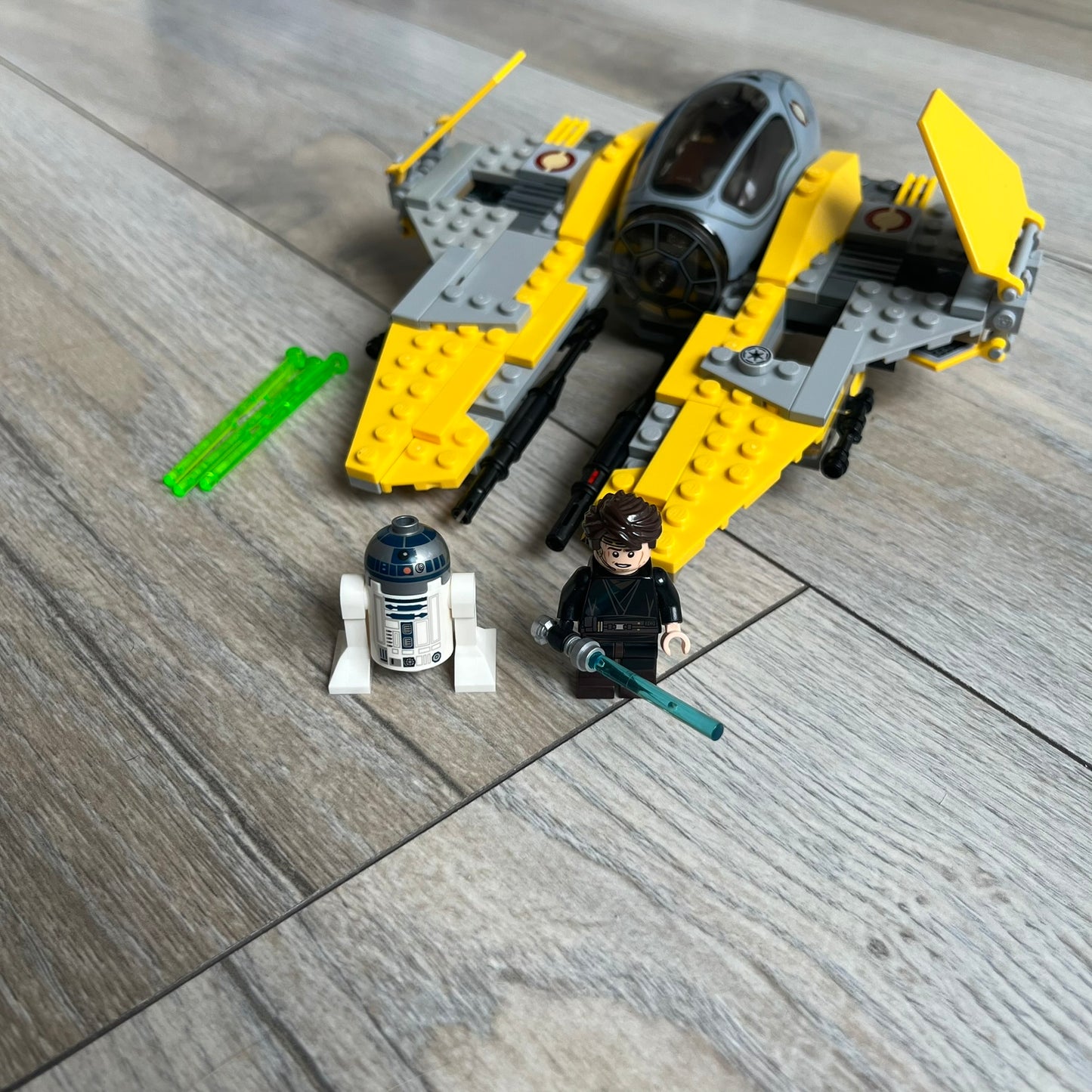 LEGO Star Wars 75038 Jedi Interceptor Set is a 2014 release featuring Anakin Skywalker’s yellow Eta-2 Actis-Class Interceptor. The set includes Anakin Skywalker minifigure with headset and lightsaber, along with an R2-D2 figure. The build features an opening cockpit, folding wing flaps, and dual spring-loaded shooters, measuring approximately 19 cm in length.