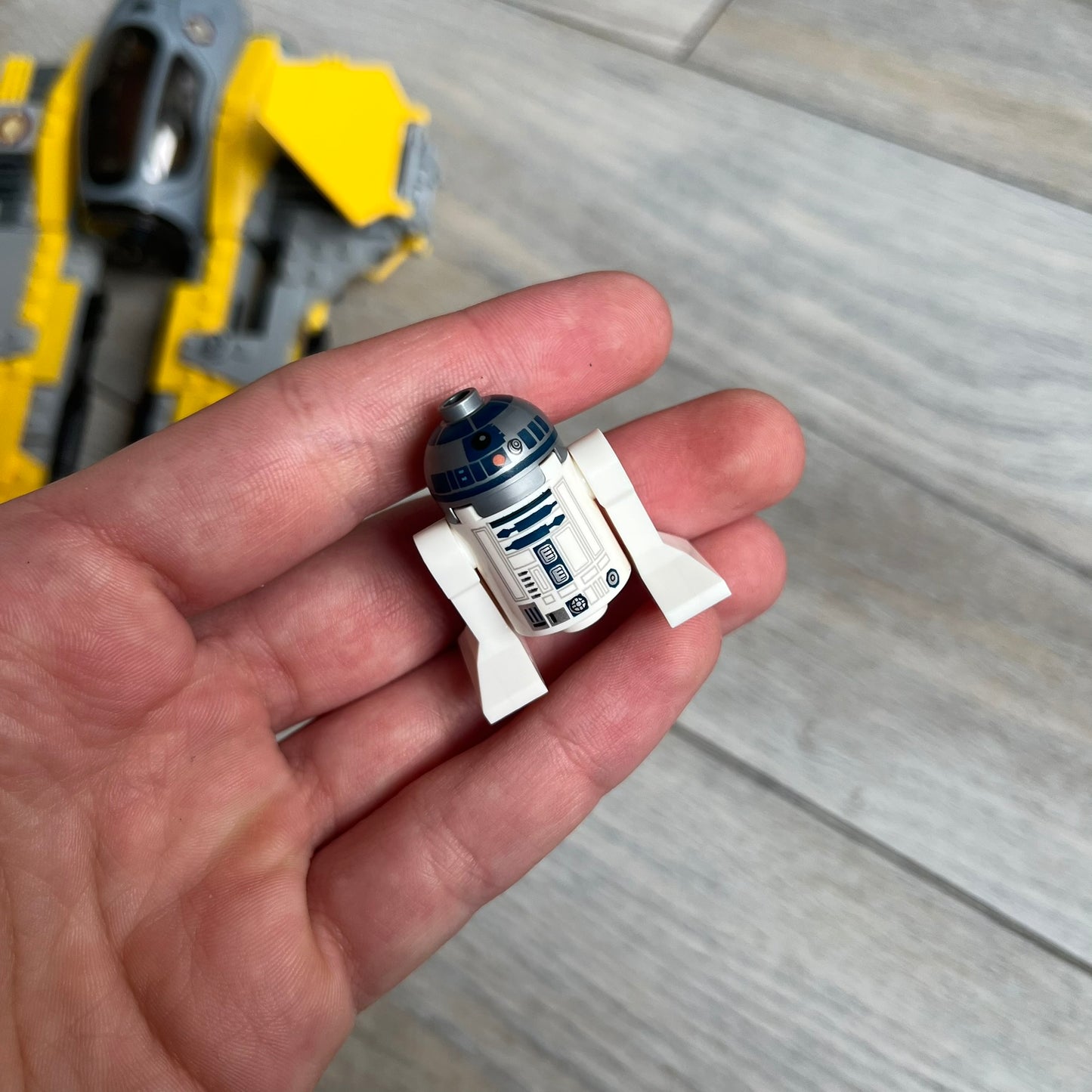 LEGO Star Wars 75038 Jedi Interceptor Set is a 2014 release featuring Anakin Skywalker’s yellow Eta-2 Actis-Class Interceptor. The set includes Anakin Skywalker minifigure with headset and lightsaber, along with an R2-D2 figure. The build features an opening cockpit, folding wing flaps, and dual spring-loaded shooters, measuring approximately 19 cm in length.