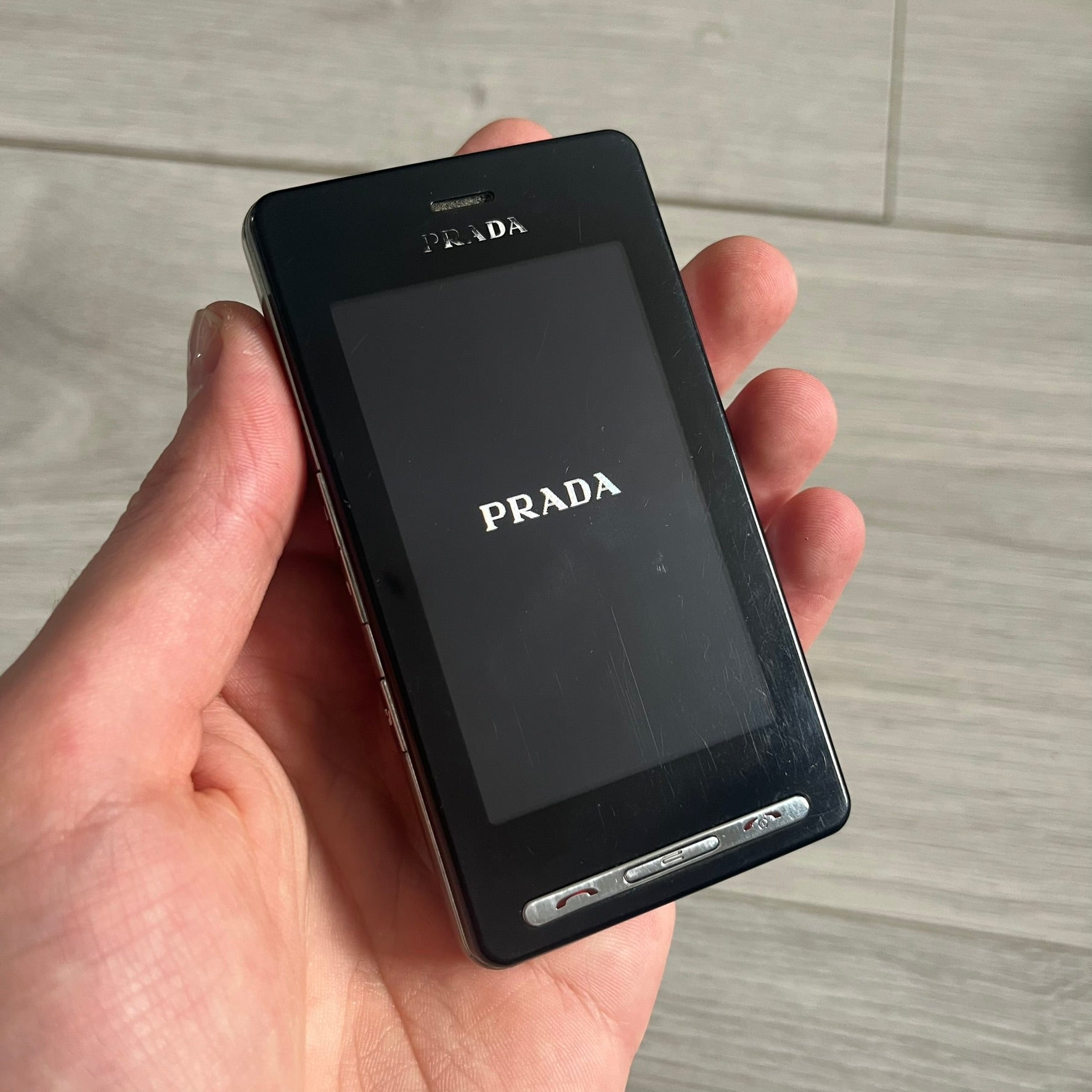 The LG Prada KE850, a groundbreaking collaboration between LG and Prada marked the world’s first capacitive touchscreen phone. Finished in sleek black with minimalist Prada aesthetics, it features media playback, Bluetooth, and expandable memory. Includes the full original Prada set: box, charger, cable, music device, manuals, and CD. Unlocked and functional for basic functions; for calling and texting you need your own SIM card.