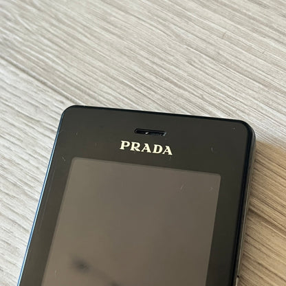 LG Prada KE850 touchscreen phone, the first of its kind with a capacitive display, designed in collaboration with Prada. Sleek black minimalist design, pre-loaded games, PDF and Office support, Bluetooth, and expandable memory. Comes complete with Prada box and leather etui - a collectible milestone in mobile fashion history.
