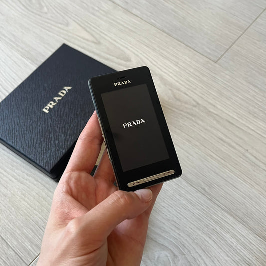 LG Prada KE850 touchscreen phone, the first of its kind with a capacitive display, designed in collaboration with Prada. Sleek black minimalist design, pre-loaded games, PDF and Office support, Bluetooth, and expandable memory. Comes complete with Prada box and leather etui - a collectible milestone in mobile fashion history.