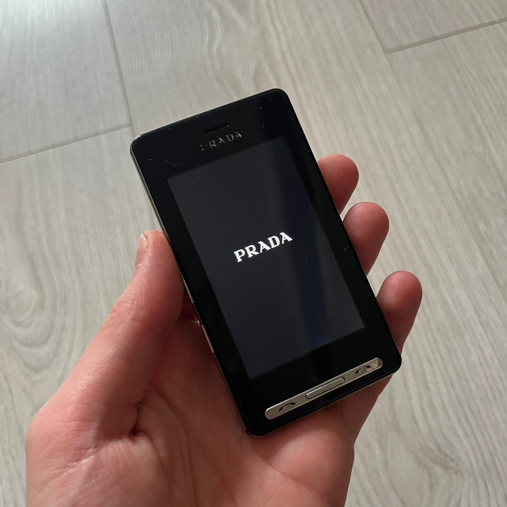 The LG Prada KE850, a groundbreaking collaboration between LG and Prada marked the world’s first capacitive touchscreen phone. Finished in sleek black with minimalist Prada aesthetics, it features media playback, Bluetooth, and expandable memory.&nbsp;